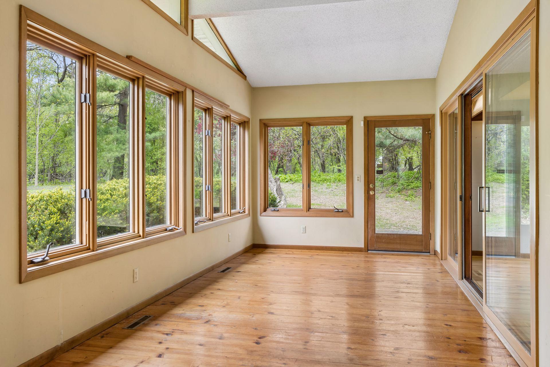 Sunroom with views of the private backyard.