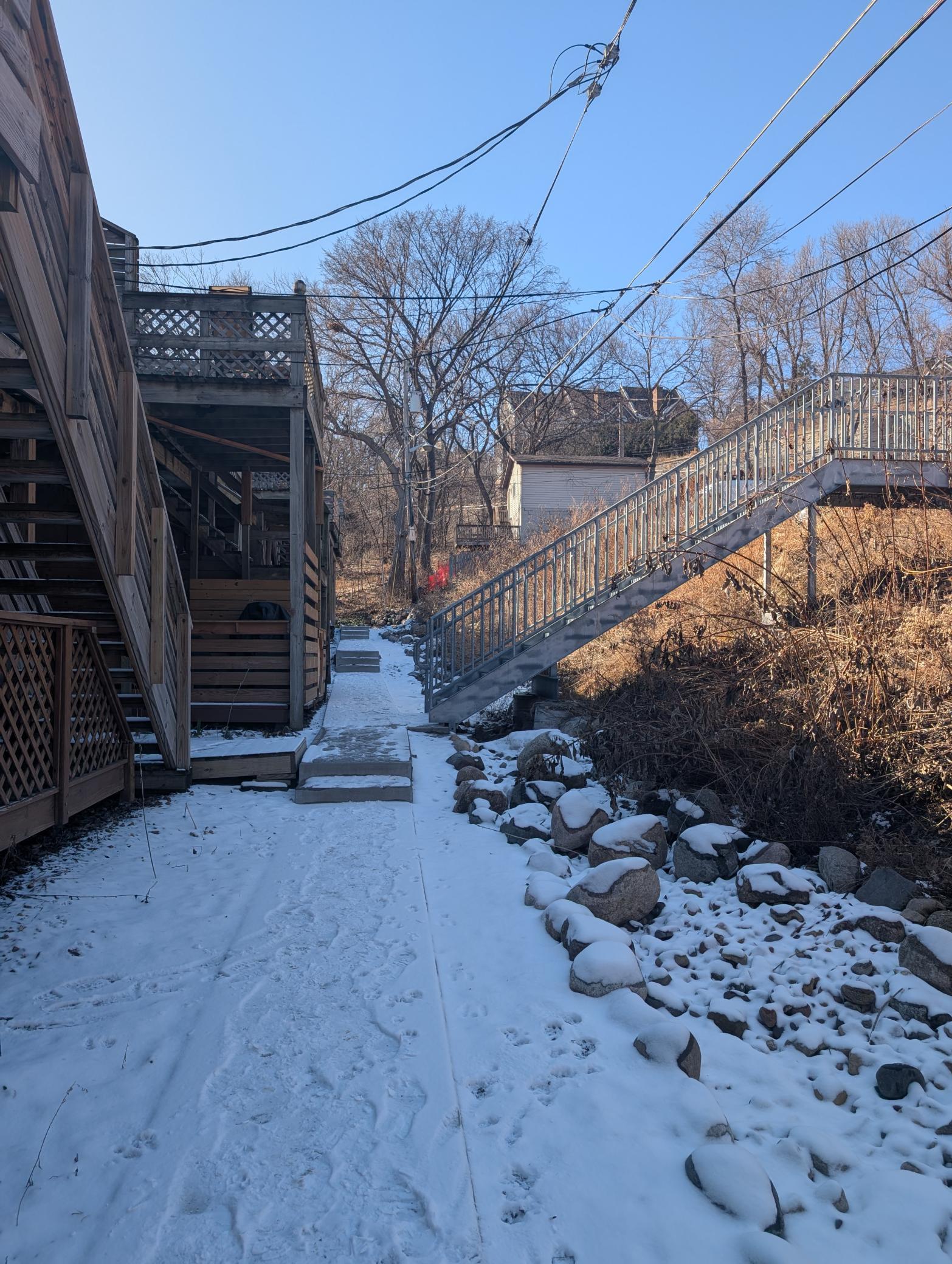 Back of building, stairs to parking and access to storage
