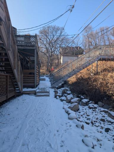 Back of building, stairs to parking and access to storage