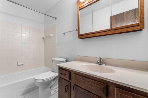 Just steps away, a full bathroom with a tub/shower combo and single vanity serves the second bedroom.
