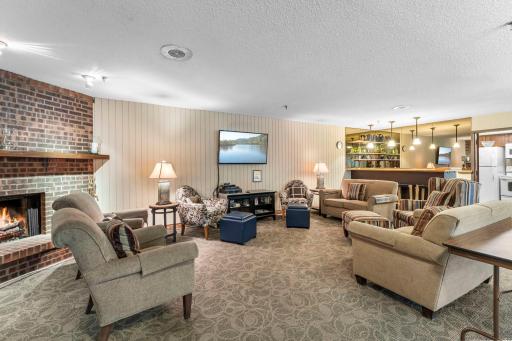 Inviting community party room featuring a fully equipped bar and kitchen.