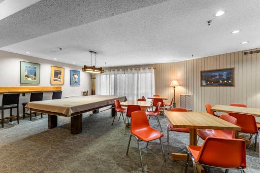 The building also offers a community room with a pool table and a party room with access to an outdoor patio and grilling area.
