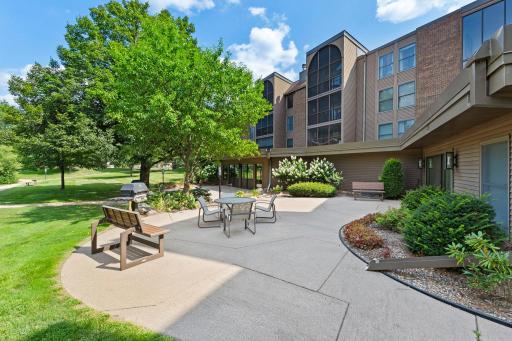 Spacious outdoor patio with several gas grills, accessible directly from the community/party roomâperfect for entertaining.
