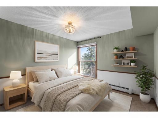 The second bedroom is generously sized, with carpeting, ample closet space, stylish light fixture, and double doors. (Digitally staged)