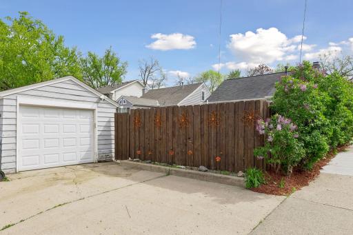 One car garage on raised concrete bed from alley. Space to put in a new 2 car garage. Current garage has opener and keeps the car and tools out of the elements.
