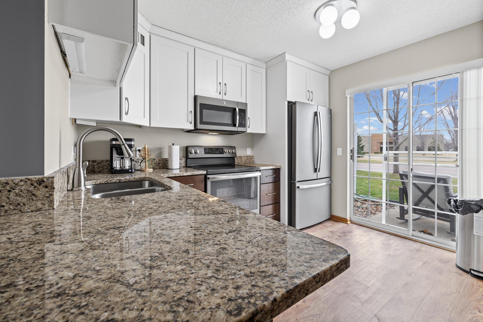 Beautifully appointed kitchen with newer cabinets, granite counters and nice appliances