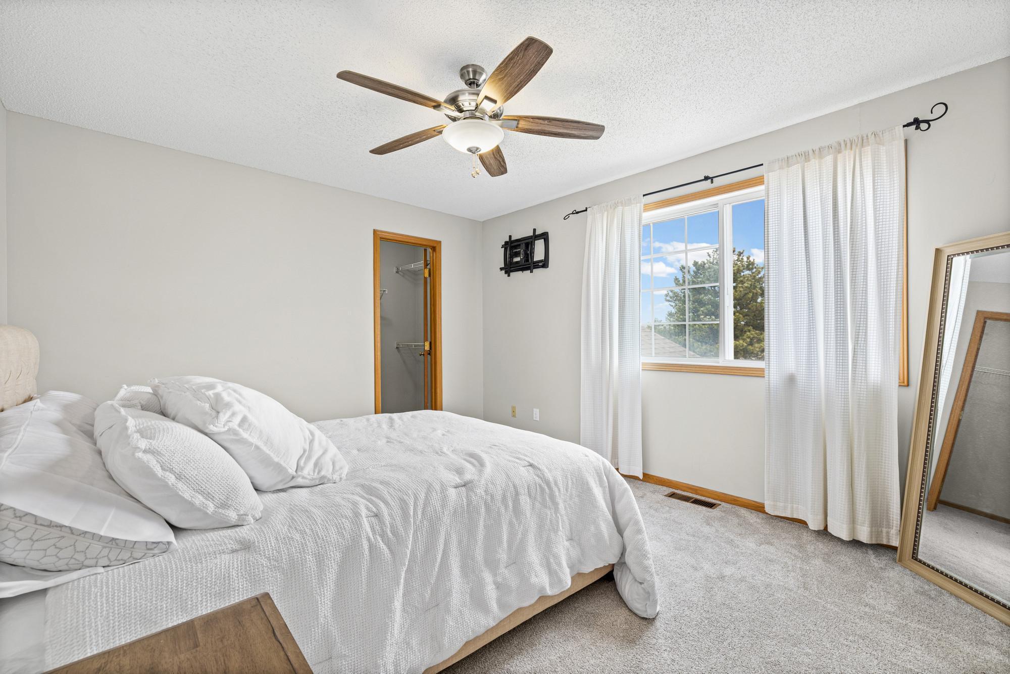 Upper level primary bedroom with walk-in closet