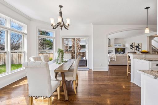 The dining room is nestled in a sun-drenched bay window with sweeping backyard views and direct access to the deck -- where every meal feels like an occasion.