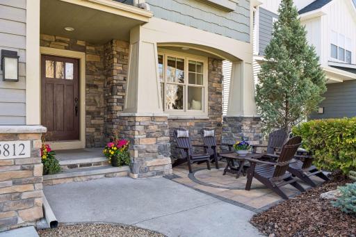 A stunning stone entry with classic pillars and a fabulous custom door set the tone and are welcoming.