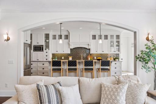 A chef's dream kitchen featuring a dramatic center island, custom cabinetry, and show-stopping lighting desing for the way you love to entertain.