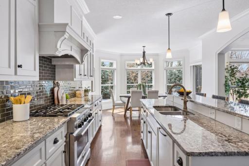 Roger Lind granite countertops, commercial grade appliances, and a light-filled layout combine to create a kitchen that is as functional as it is breathtaking.