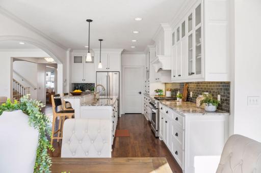 Custom cabinetry crafted with precision and purpose offers both stunning style and thoughtful storage -- the kink of detail that sets this kitchen apart.