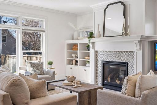 Custom built-ins frame the living room with purpose and elegance, offering a beautiful display space and smart storage that keeps the room as functional as it is stunning.