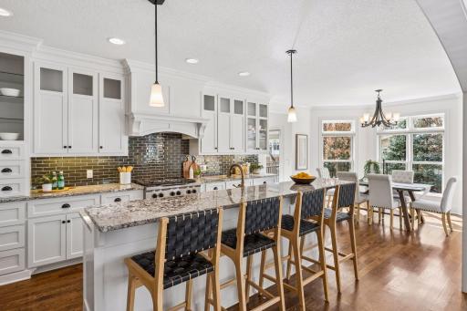 The kitchen and dining area flow together in perfect harmony, a seamlessly connected space designed for everything from casual weeknights and dinners to elegant entertaining.