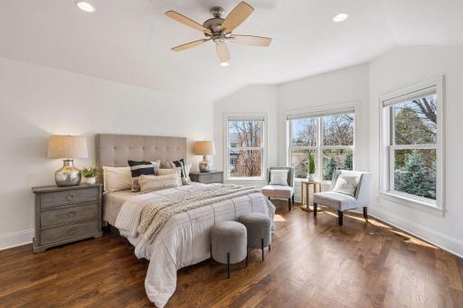 The upper-level primary suite is a true retreat: a sun-drenched bay window, generous sitting area, and a layout that effortlessly accommodates a king bed plus all the furnishings a luxury suite deserves.