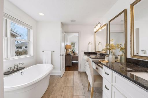 From the rich granite double vanity to the statement mirrors, deep soaking tub, and floor-to-ceiling tiled shower surround, the primary bath delivers the kind of refined and spa-inspiring