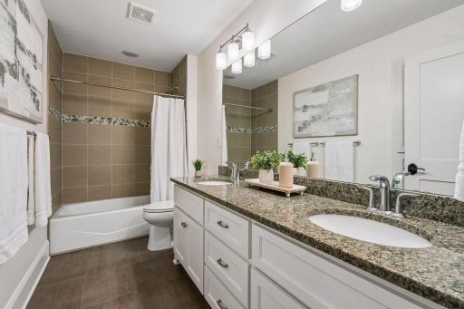This gorgeous guest bath impresses with fresh countertops, a beautifully updated shower, and a crisp finish throughout. A polished move-in ready space that leaves nothing to be desired.