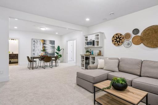 The lower level strikes the perfect balance between polished and playful, a beautifully finished space ready to serve as a game room, media lounge, and/or the ultimate hangout for family and guests alike.