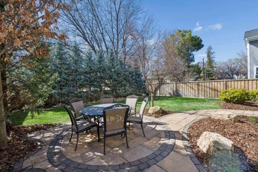 With layered landscaping, a serene stone water feature, lush new plantings, and a privacy fence that wraps the backyard into seclusion, the outdoor living experience here is nothing short of extraordinary.