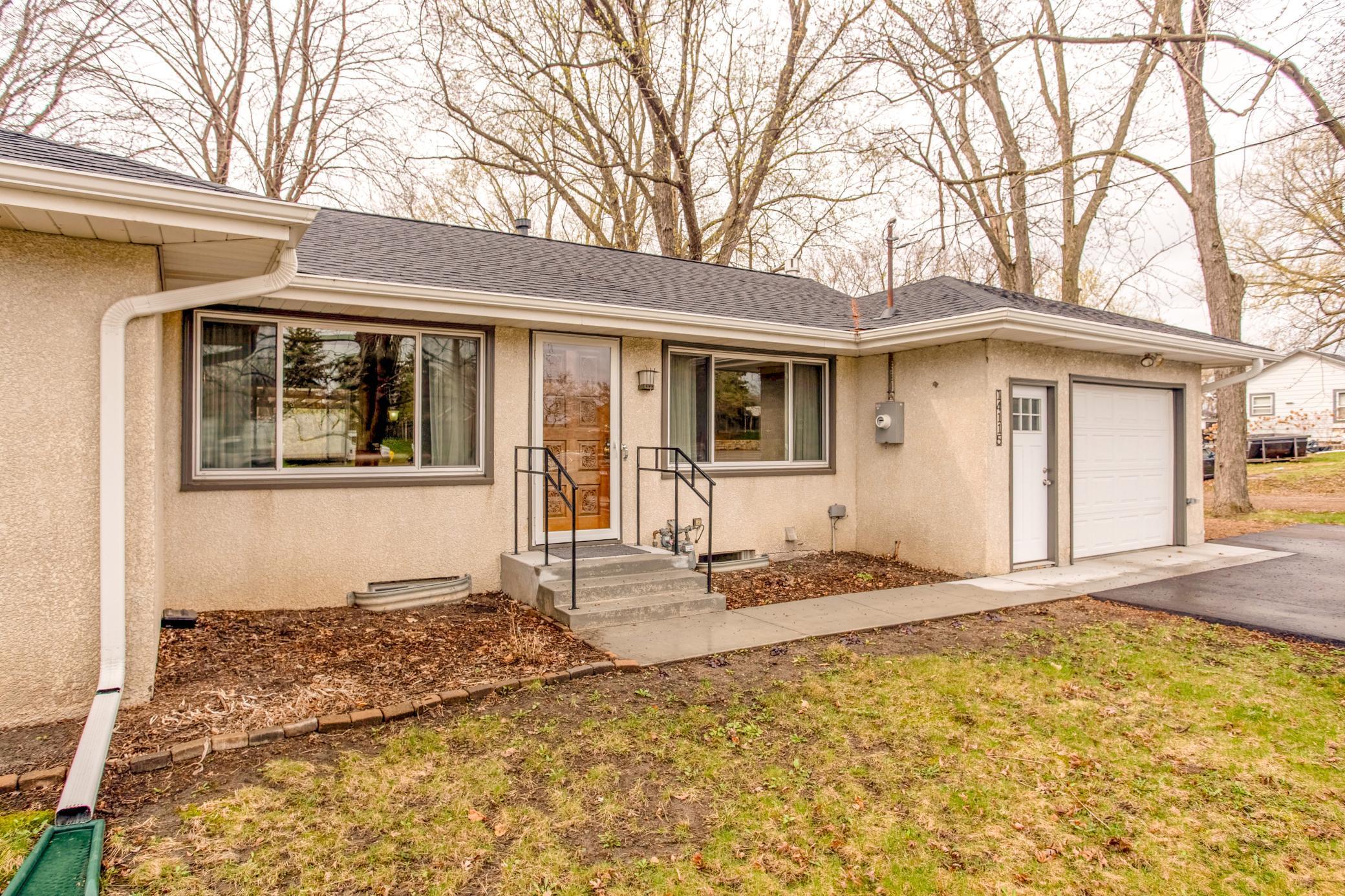 Welcoming front entry with clean lines, large windows, and easy access to the attached garage.