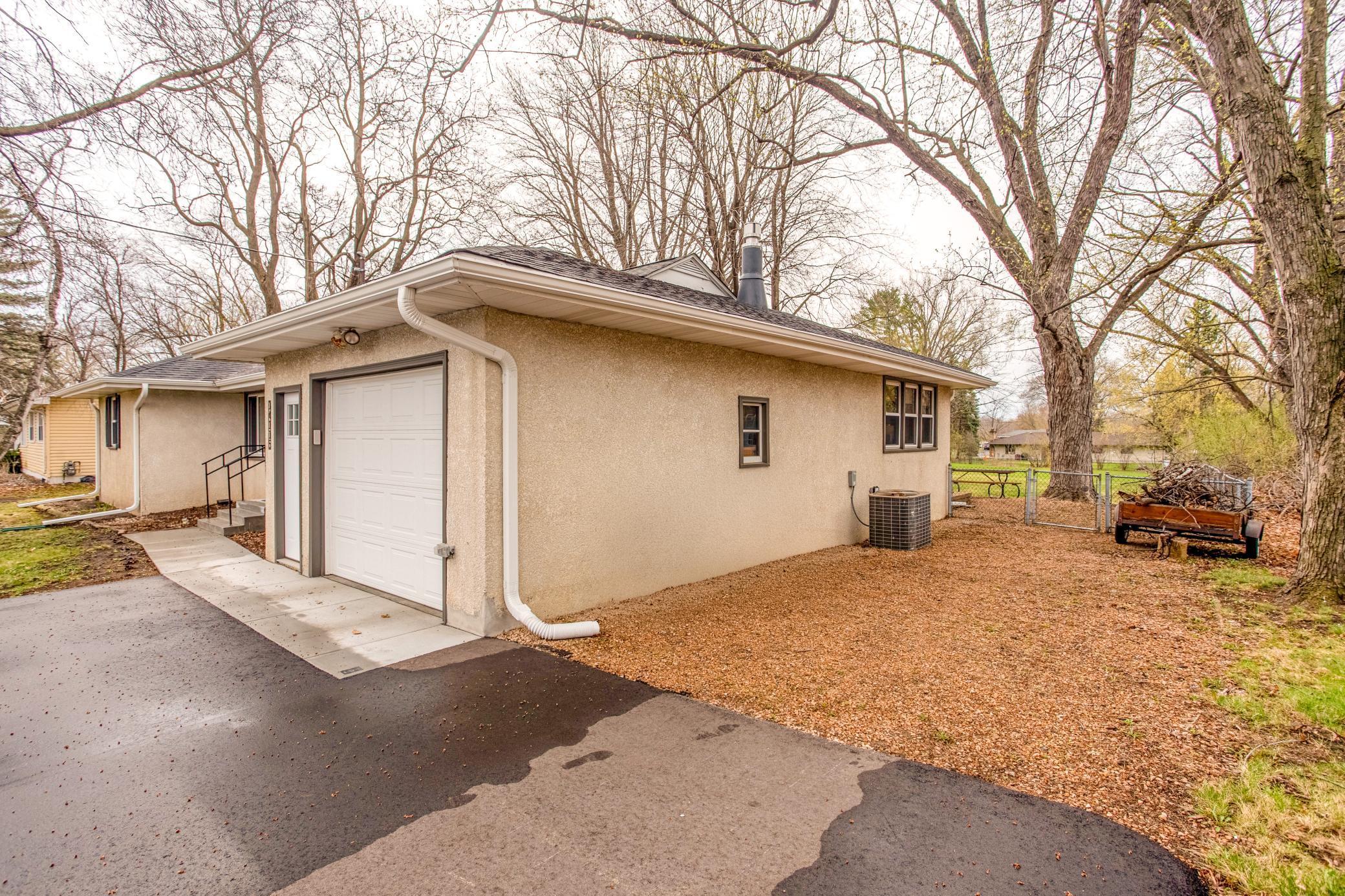Extended driveway leading to an attached garage, offering ample parking and convenient access to the home.