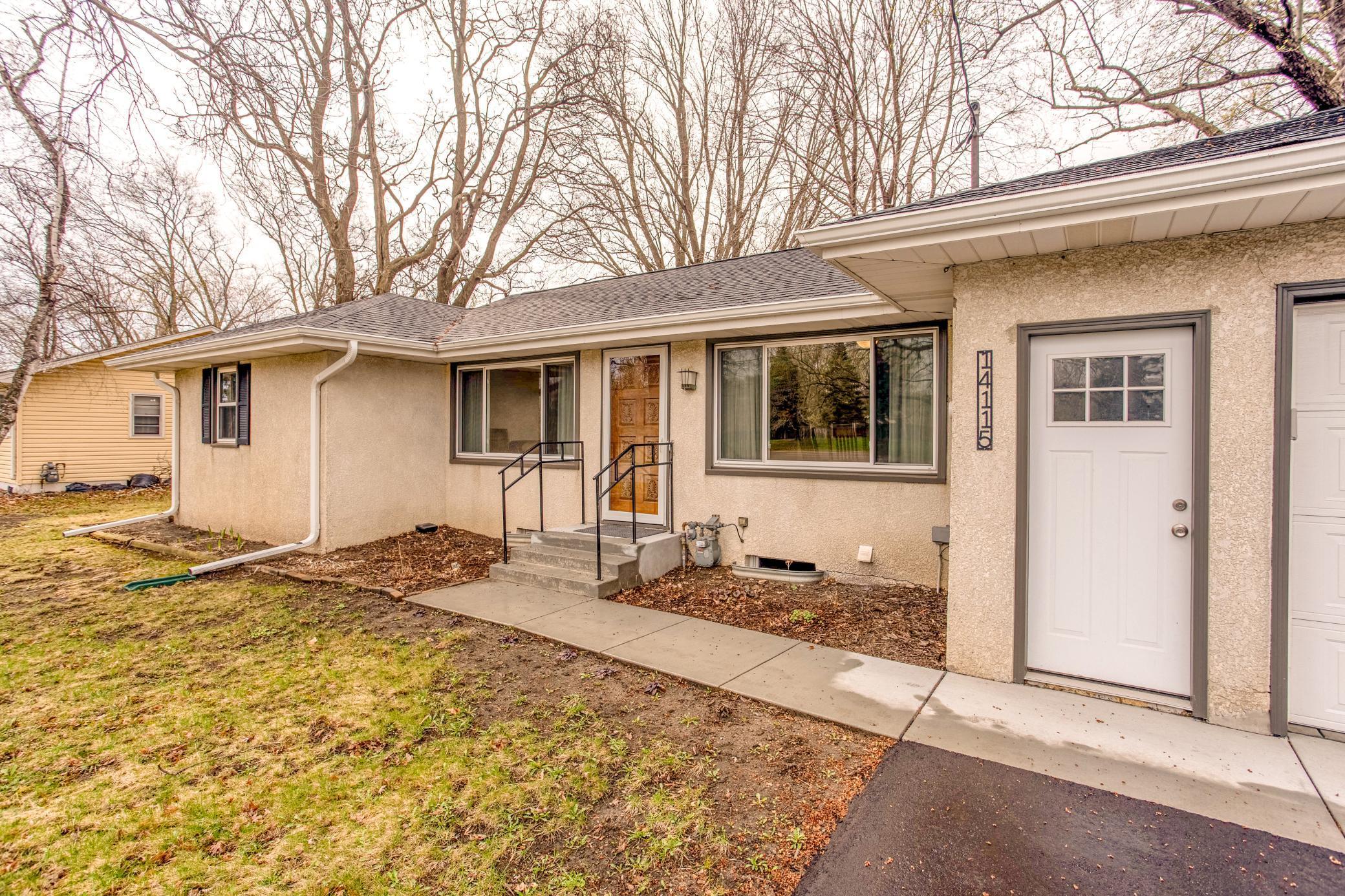 Welcoming front entry with clean landscaping and easy access to the attached garage.