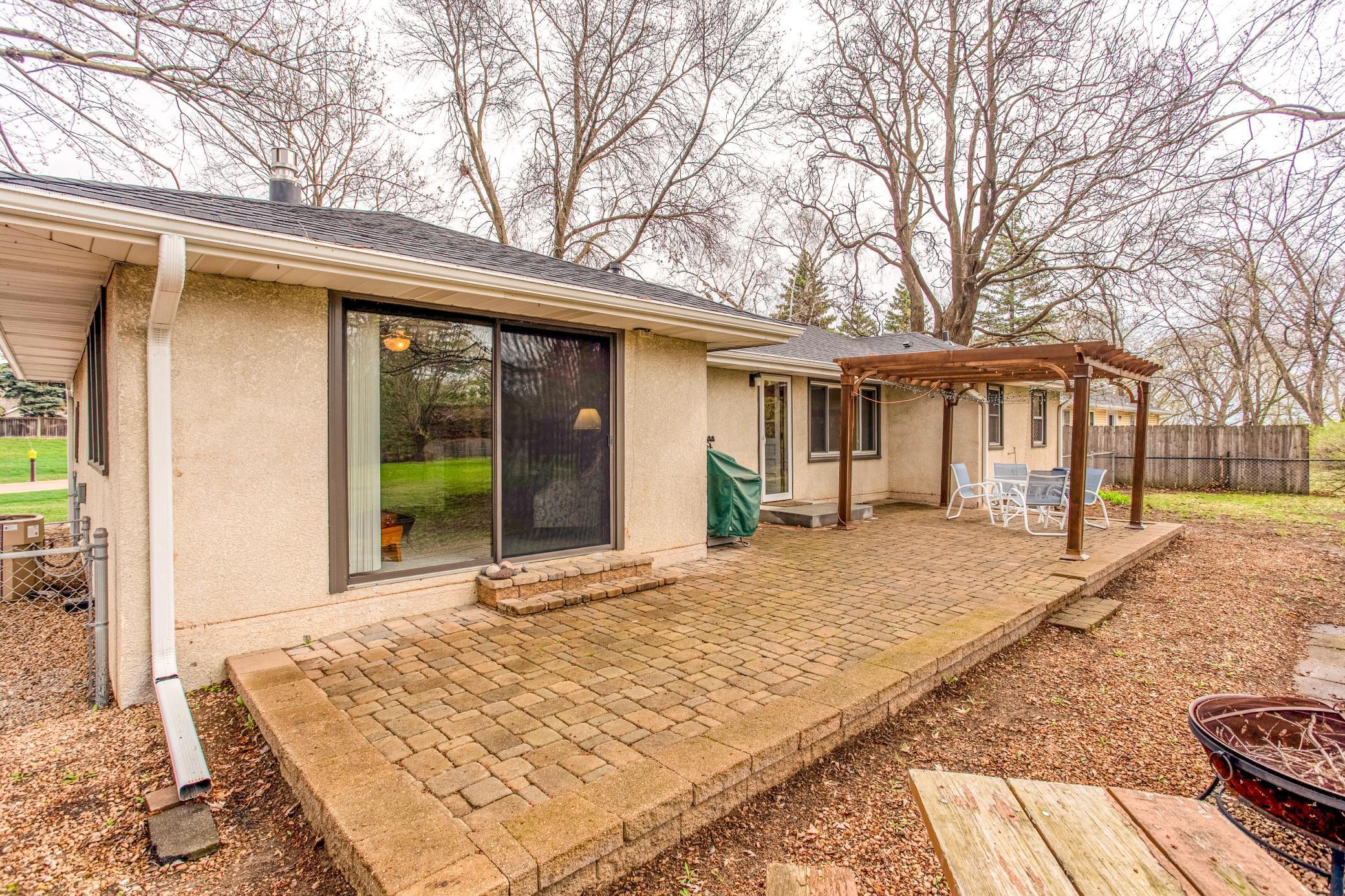 Large patio area with sliding door access, seamlessly connecting indoor and outdoor living spaces.