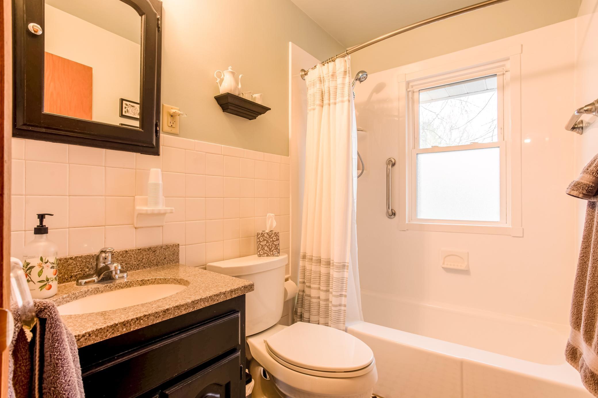Updated and functional full bathroom with updated vanity and tub/shower combination.