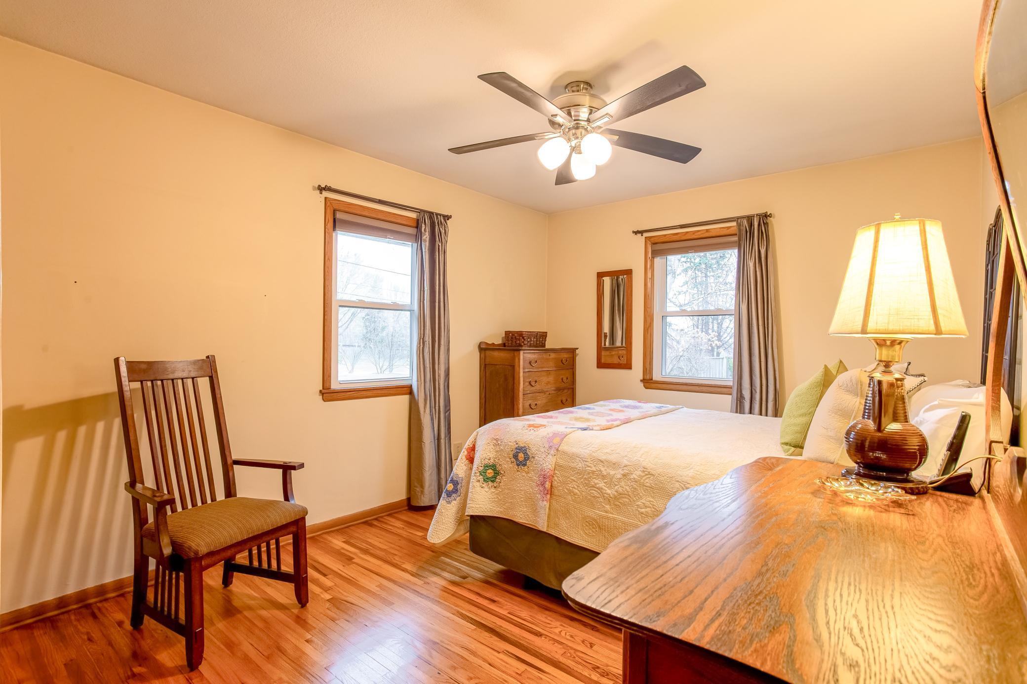 Spacious primary bedroom with hardwood floors and abundant natural light.