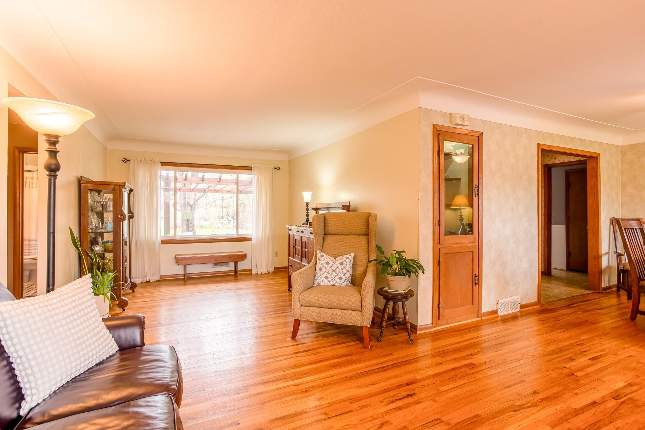 Bright and spacious living room with classic finishes and cove ceilings.