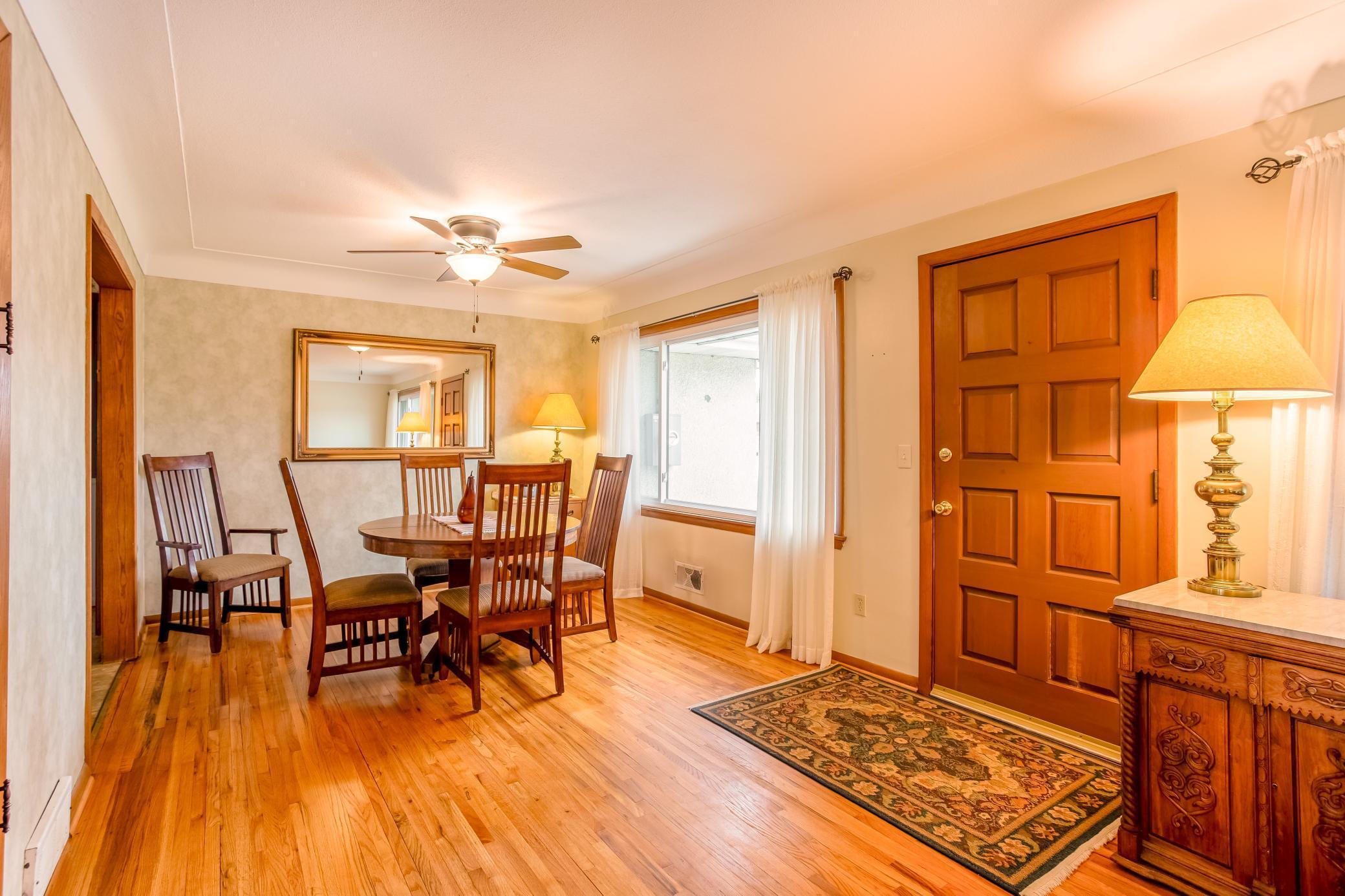 Charming dining space with easy access to the kitchen and views of the front yard.