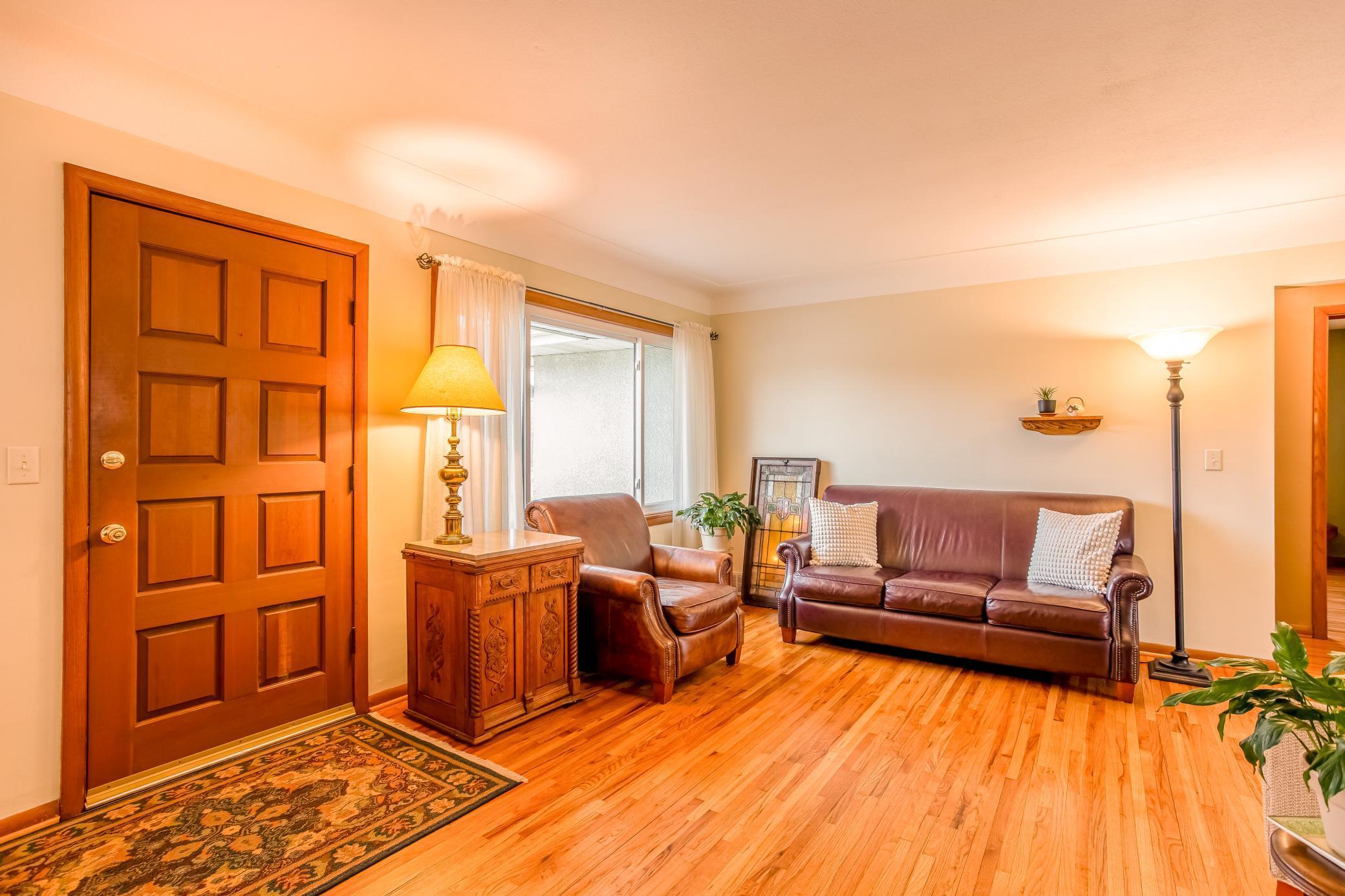 Warm and inviting living room with hardwood floors and abundant natural light.