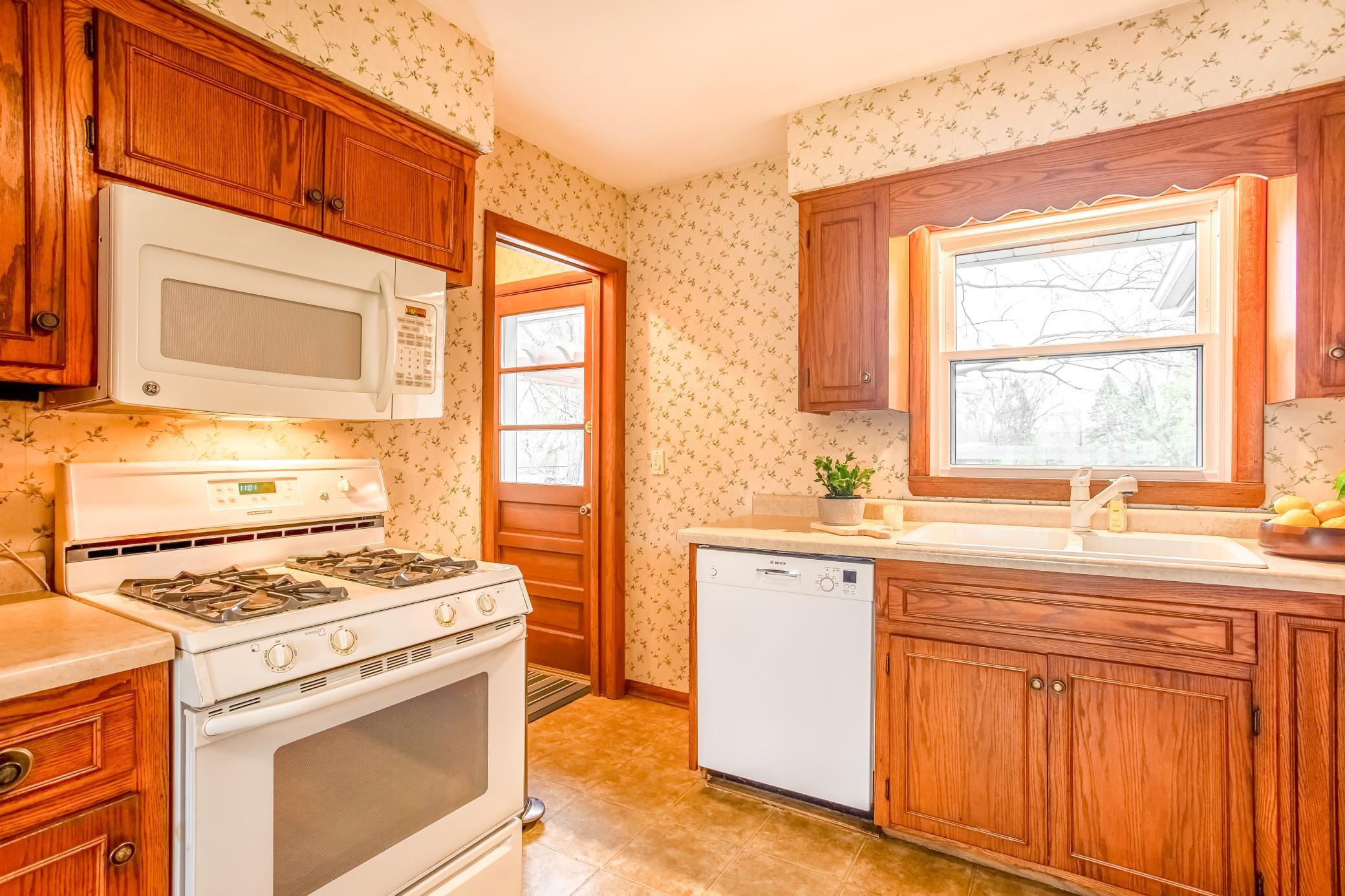 Efficient layout with generous counter space and convenient access to the backyard.