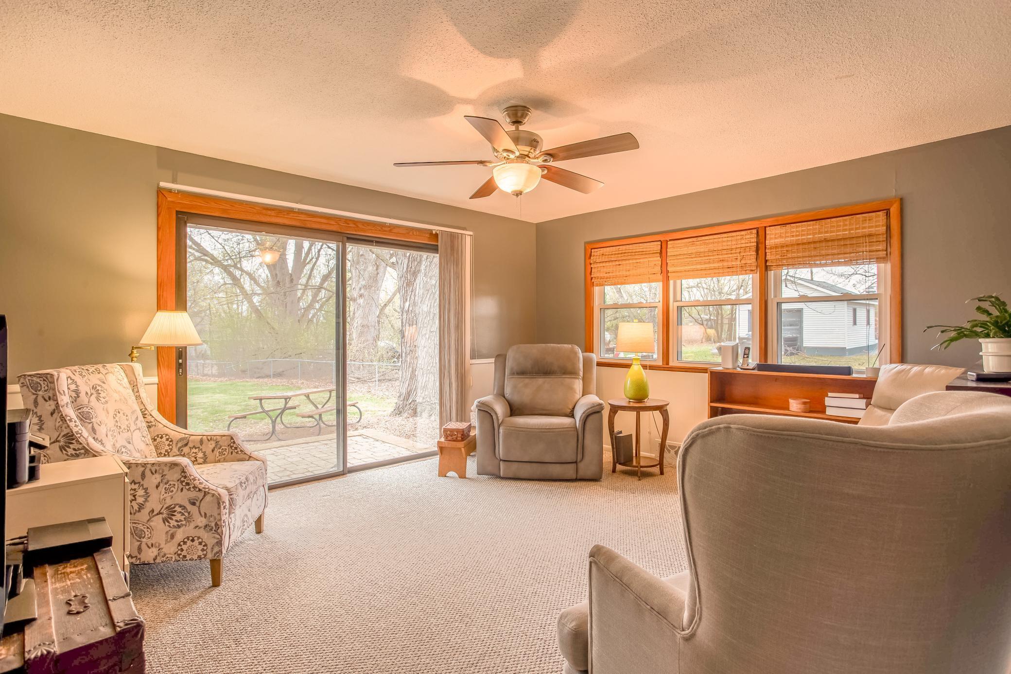 Cozy family room with large windows and an oversized sliding glass door leading to the backyard patio.