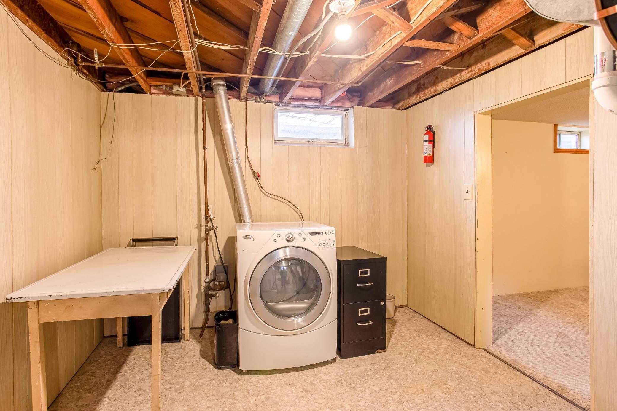 Conveniently located laundry and mechanical area with easy access to lower-level living spaces.