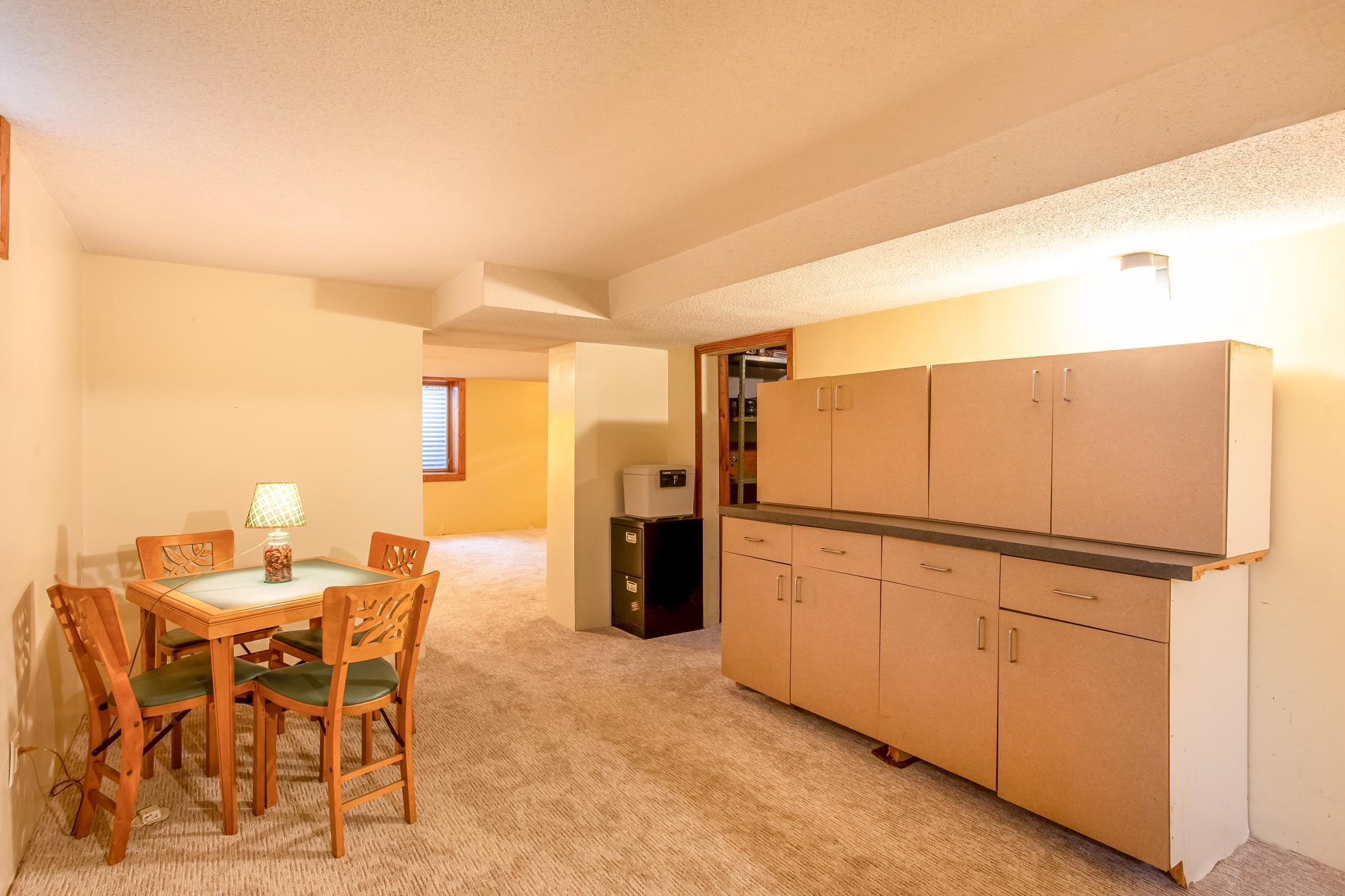 Spacious lower-level hobby space with versatile layout—perfect for relaxing, entertaining, or a home office setup.