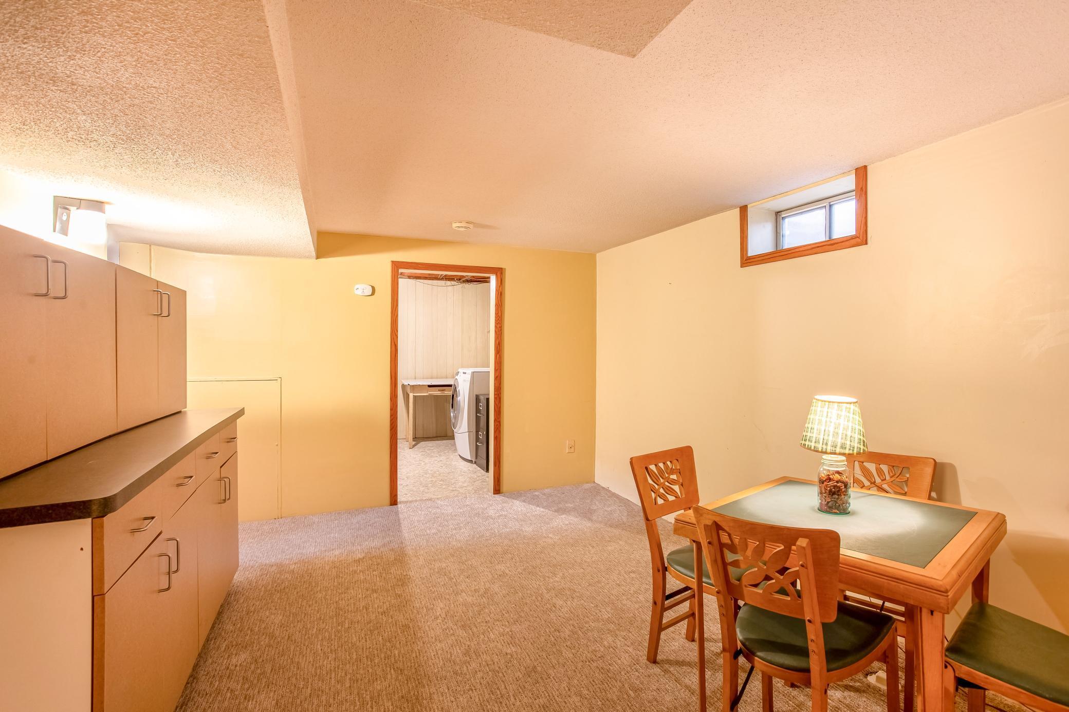 Cozy game area with built-in cabinetry, providing added storage and functionality.