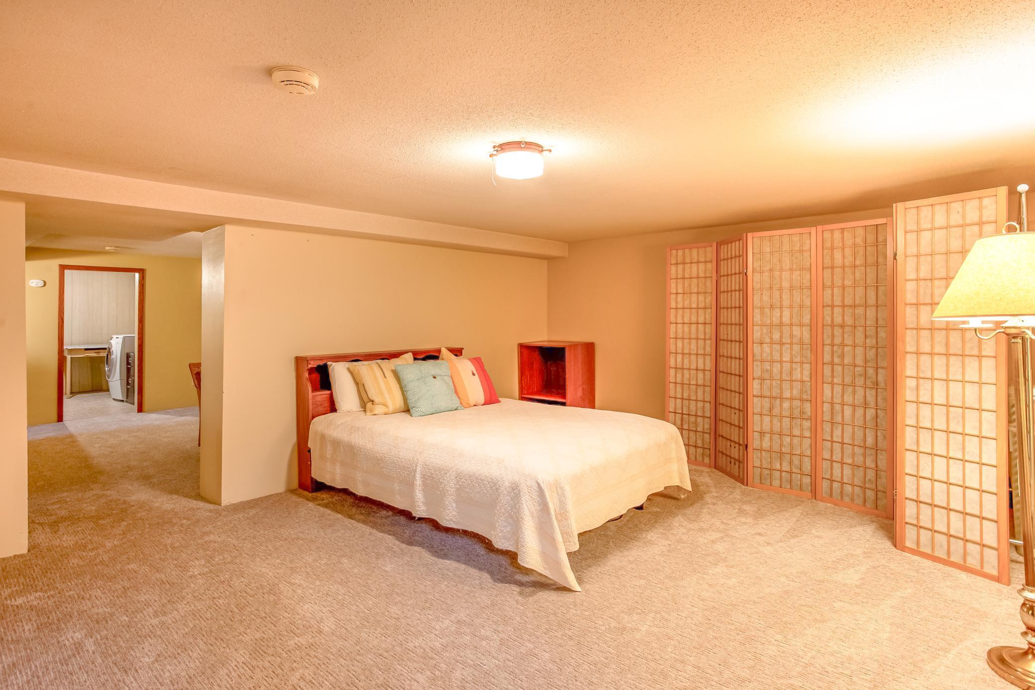 Large lower-level rec room with ample space and privacy, ideal for guests or a private retreat.