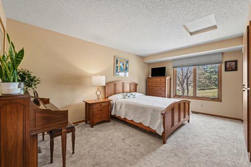Main-level bedroom with a large window with more beautiful park views