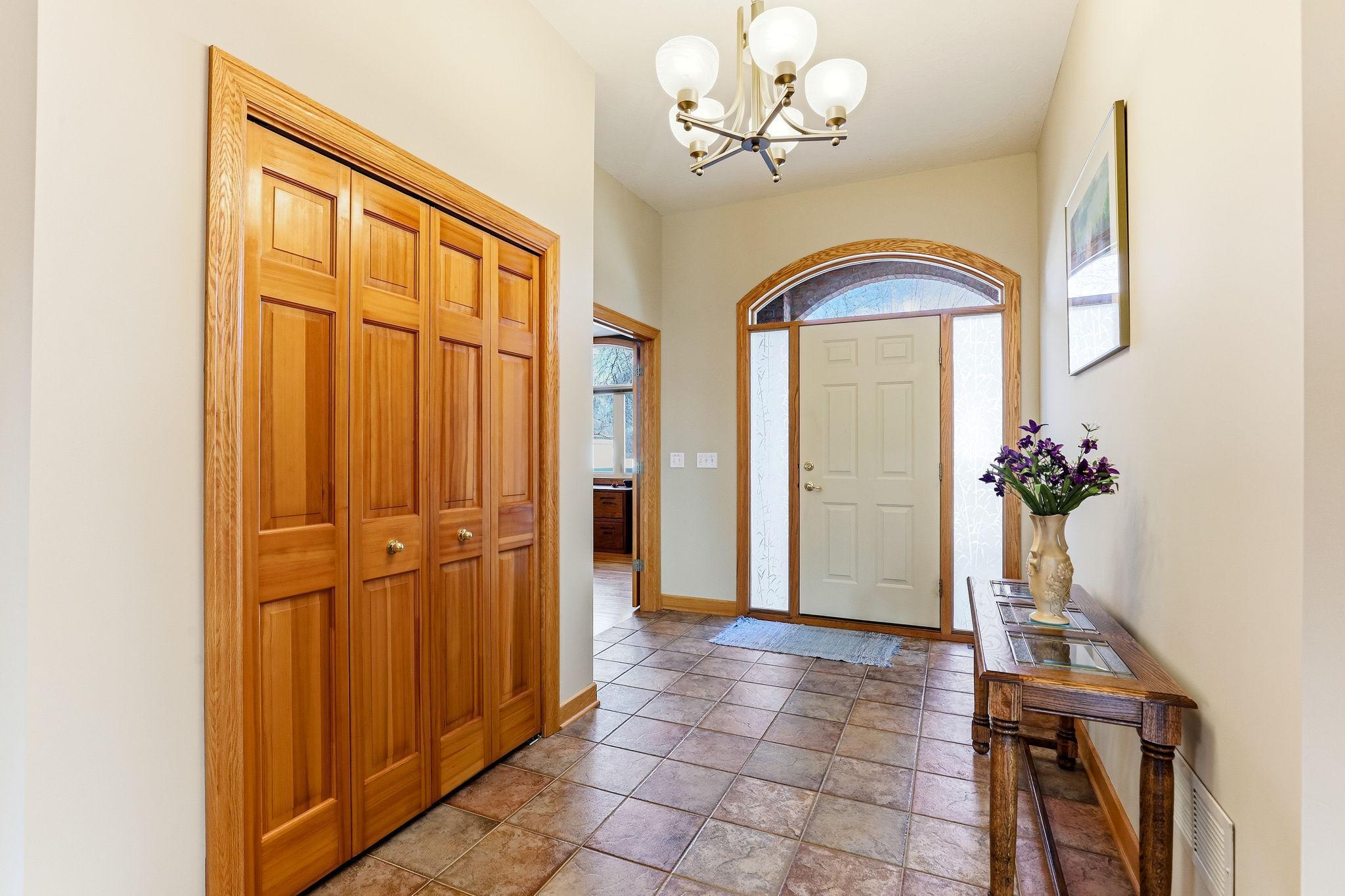 Elegant tiled foyer offering generous space and a discreetly placed front closet.