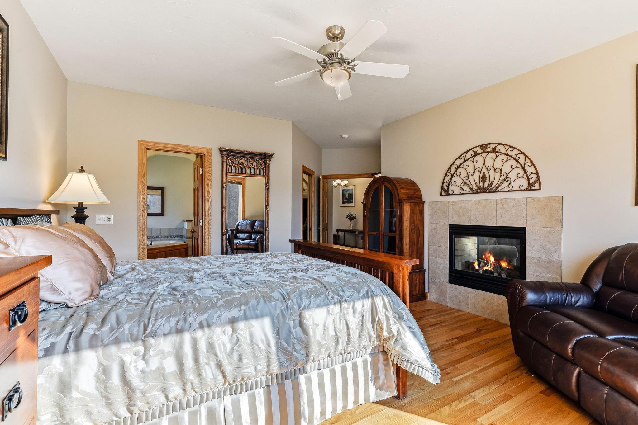 Luxurious owner’s suite highlighted by a see-through fireplace seamlessly shared with the living room