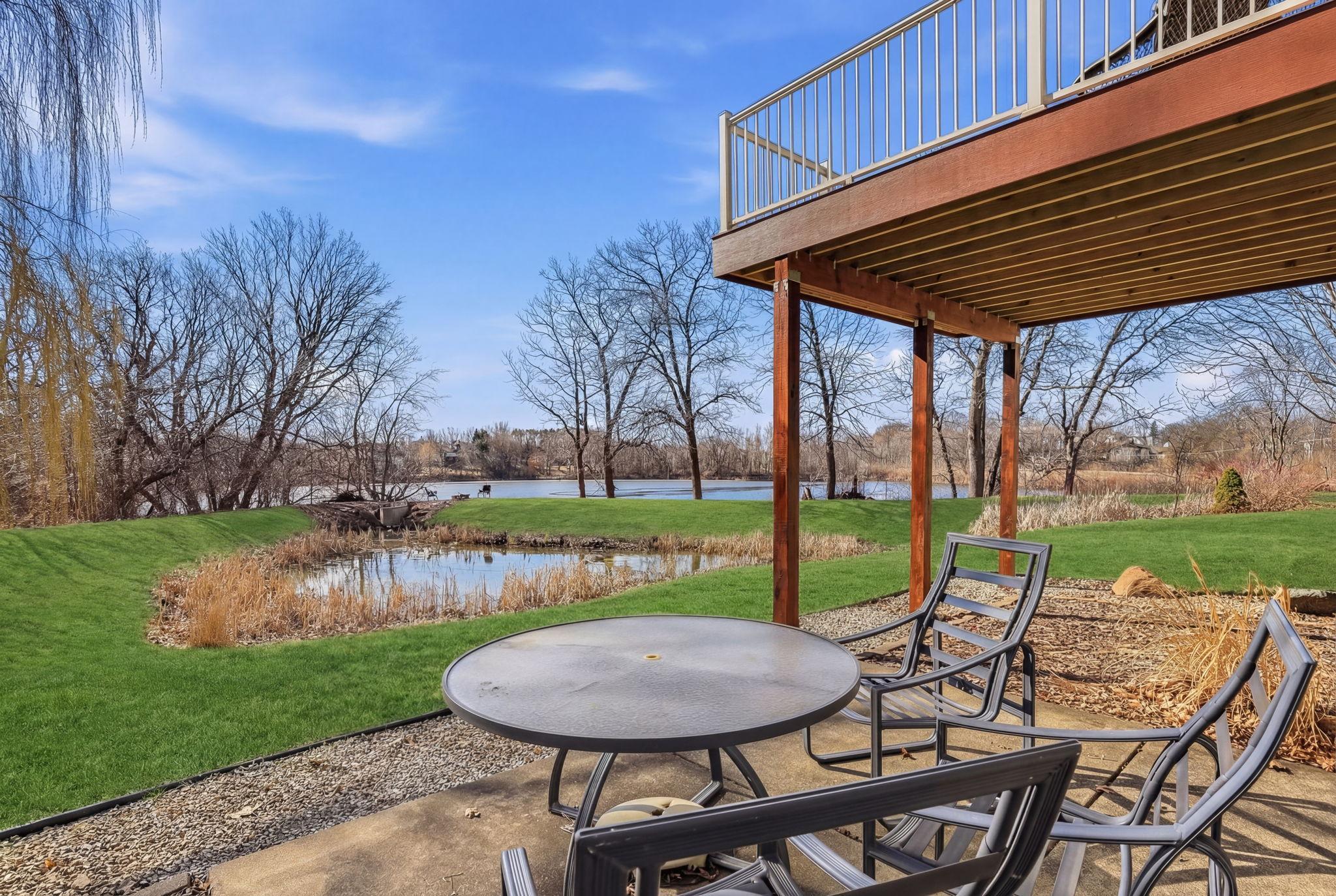 Outdoor patio with breathtaking views of the lake and pond—perfect for relaxing, entertaining, and enjoying serene waterside scenery