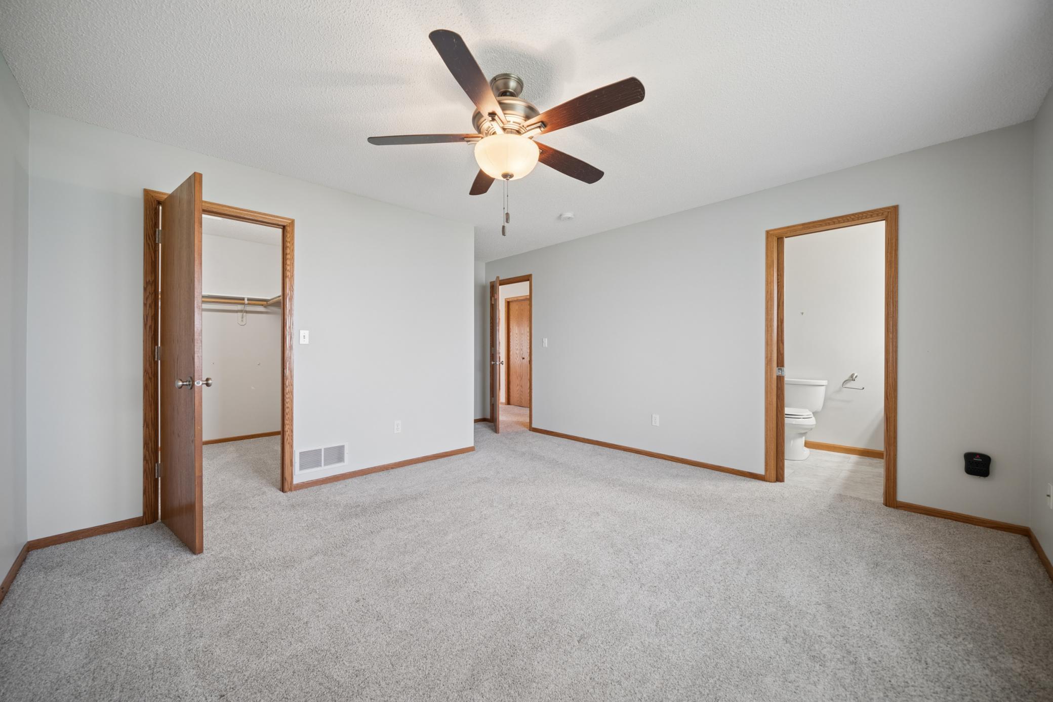 Primary with walk-in closet and private bath featuring walk-in shower