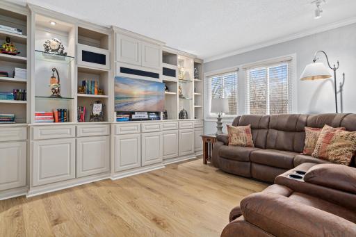 Light-filled living room featuring large windows and stylish custom built-ins.