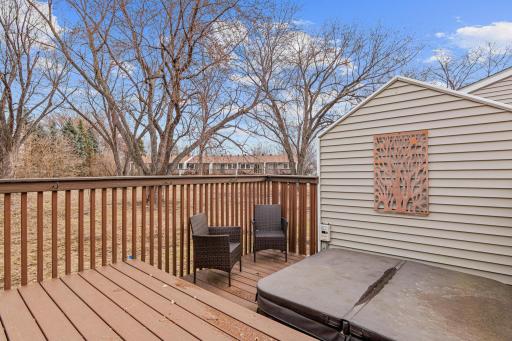 Private deck with stairs providing direct access to the lush backyard.