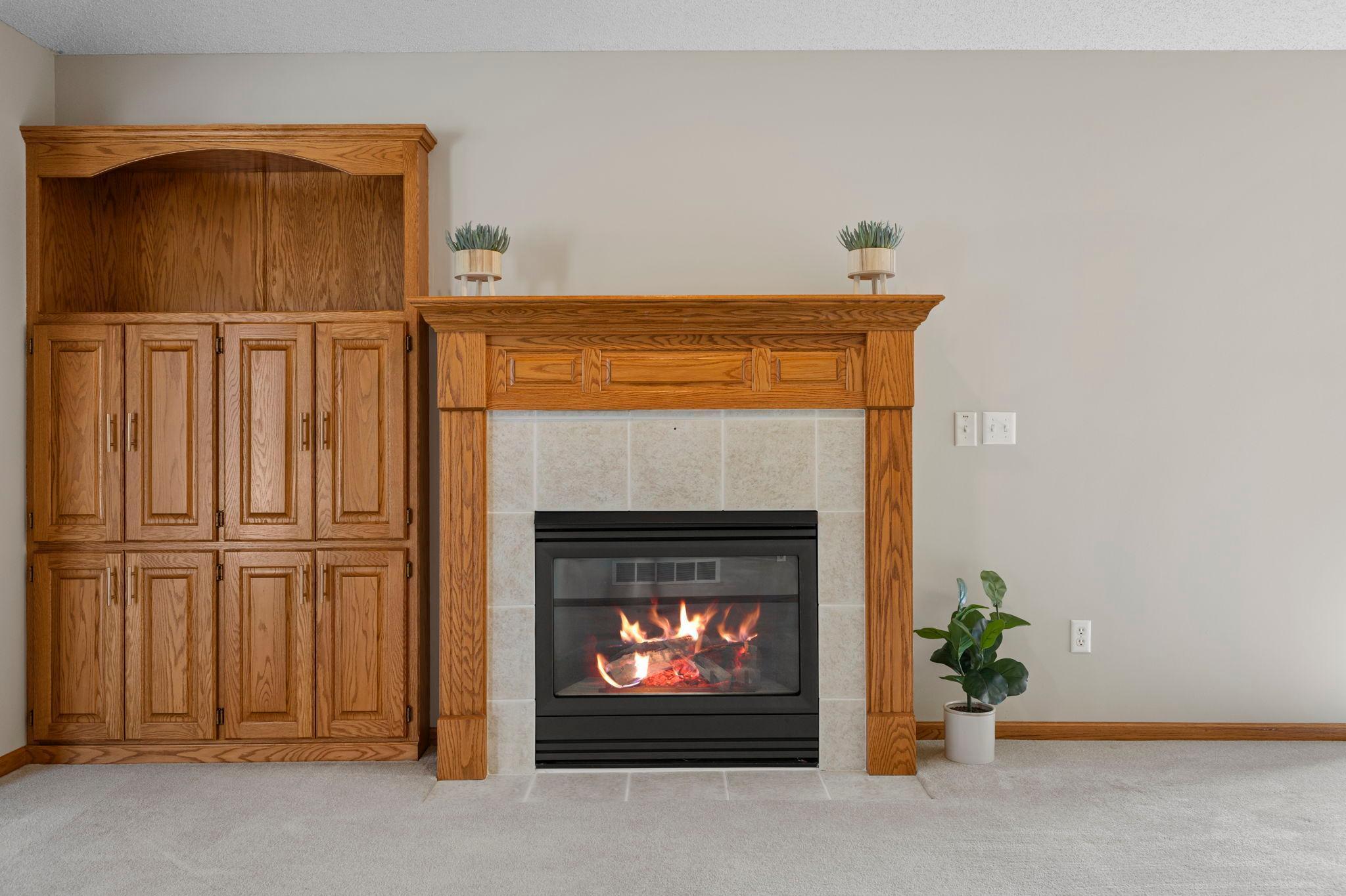 The living room is centered around a gas fireplace adding warmth and a cozy ambiance.