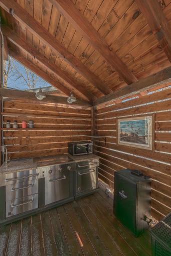 Outdoor kitchen with stainless steel appliances and granite countertop