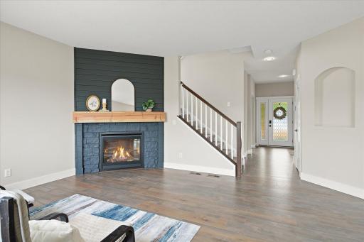 The floor-to-ceiling gas fireplace creates a striking focal point in the living room.
