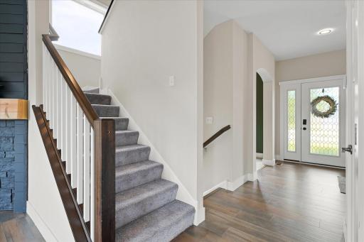 An elegant staircase with a sunlit landing for added warmth.