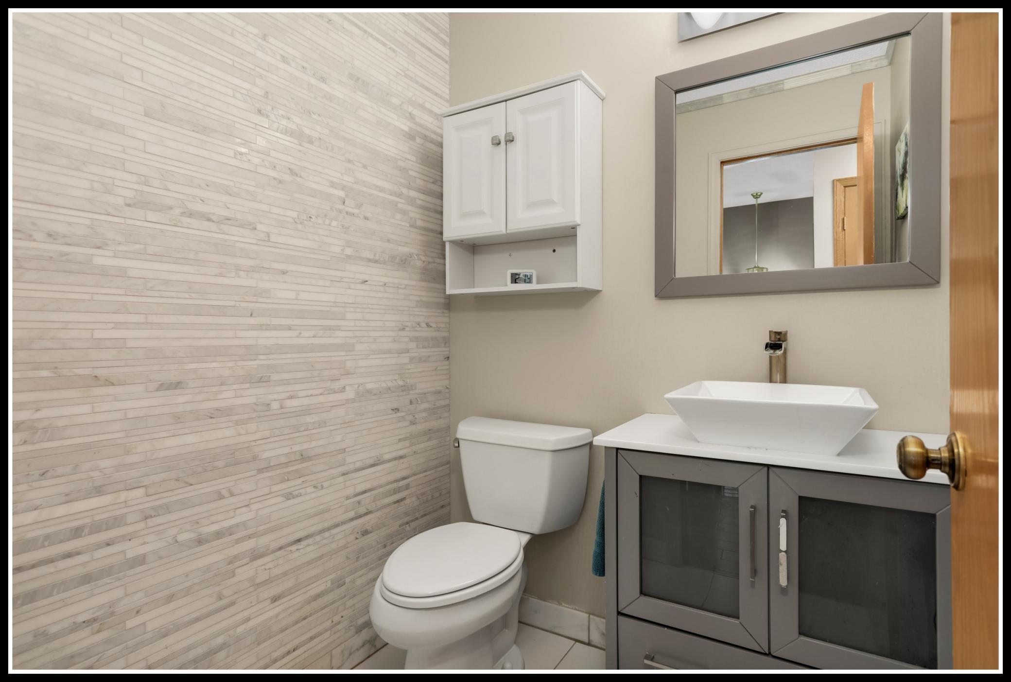 An updated half-bathroom serves guests at the main level